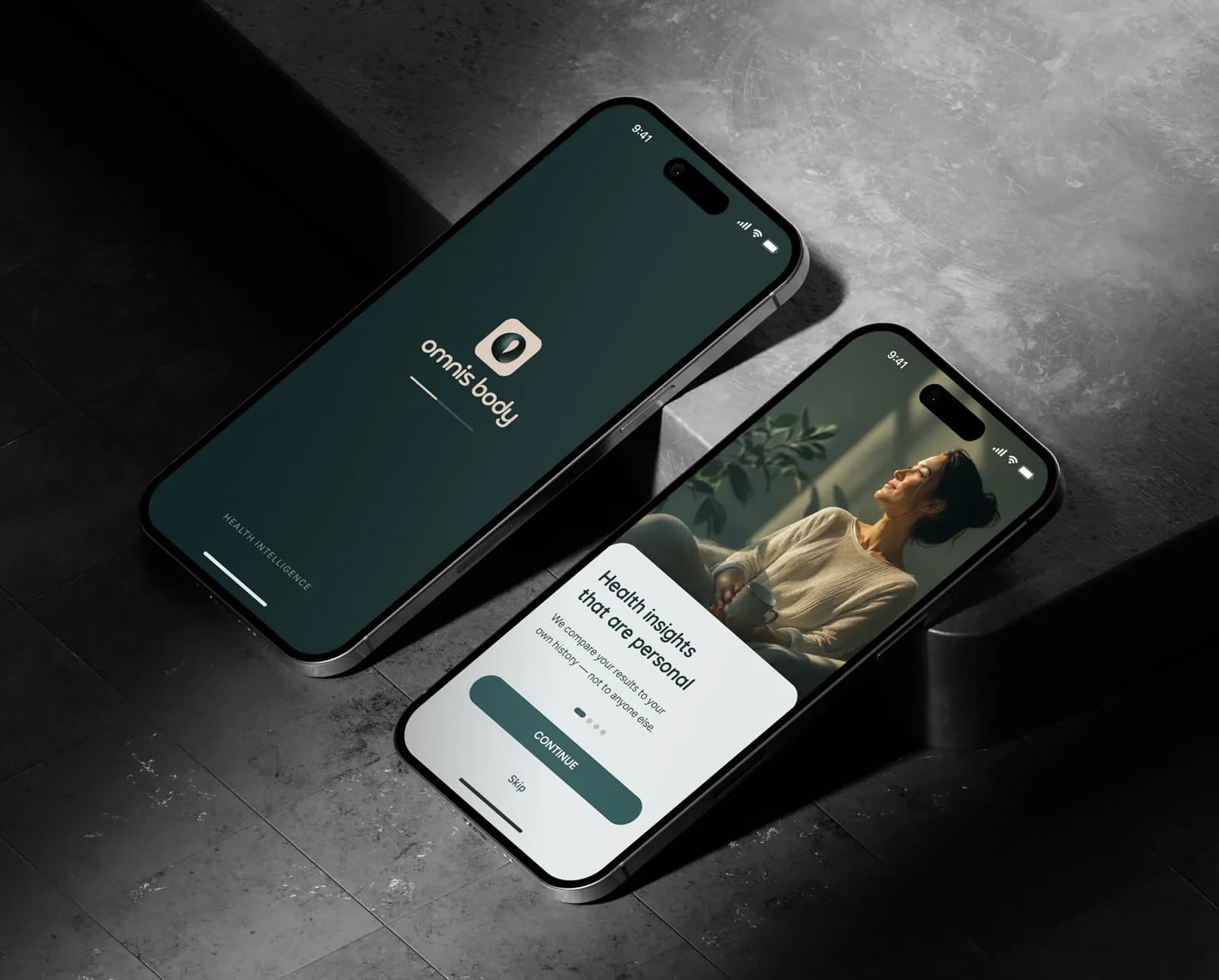 Two phones on a dark stone surface showing the Omnis Body splash screen and onboarding.